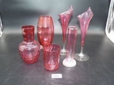 A small quantity of Cranberry glass including a pair of Calla lily shaped vases,