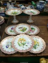 An elegant dessert set with pink and gilt rims and floral centres comprising of two comports (both