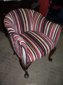 A stylish tub shaped Armchair standing on cabriole front legs with pad feet and carved knees and