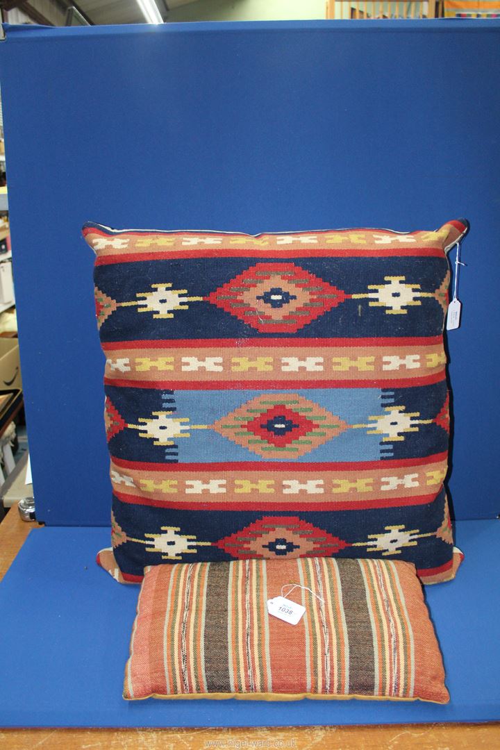 A Turkish Kelim Cushion, 18" x 10" and a large Kelim covered cushion, 2' 6" x 2' 3".