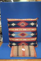 A Turkish Kelim Cushion, 18" x 10" and a large Kelim covered cushion, 2' 6" x 2' 3".