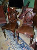 A good pair of circa 1900 Mahogany solid seated Hall Chairs having shaped seats and back rests with