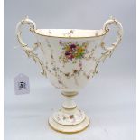 A Coalport trophy vase with trailing sprays of flowers on a white ground and gold coloured