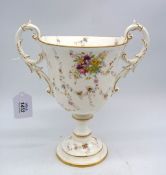 A Coalport trophy vase with trailing sprays of flowers on a white ground and gold coloured