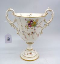 A Coalport trophy vase with trailing sprays of flowers on a white ground and gold coloured