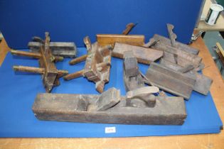 A quantity of vintage woodworking planes including coffin planes.