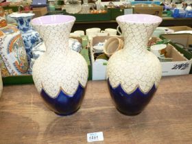 A pair of Thomas Forester vases, in deep blue, cream and gilt with lilac interior 10" tall.