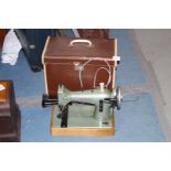 A vintage electric sewing machine 'CSE' made by Jones' sewing machine company, Manchester, cased.