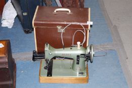 A vintage electric sewing machine 'CSE' made by Jones' sewing machine company, Manchester, cased.