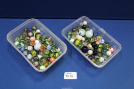 Two boxes of marbles.