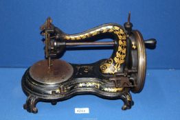 A heavy Jones lock stitch hand sewing machine.