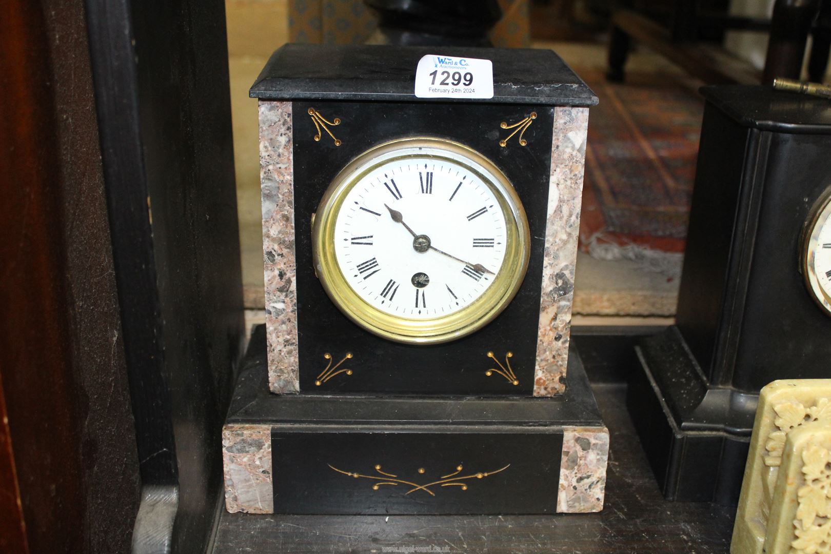 A slate and marble Mantle Clock having gold painted inset details, Roman numerals on a white face,