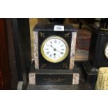 A slate and marble Mantle Clock having gold painted inset details, Roman numerals on a white face,