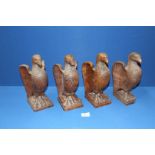 A set of four carved wooden Eagle Newel post Caps, 10 1/2'' high, all a/f.