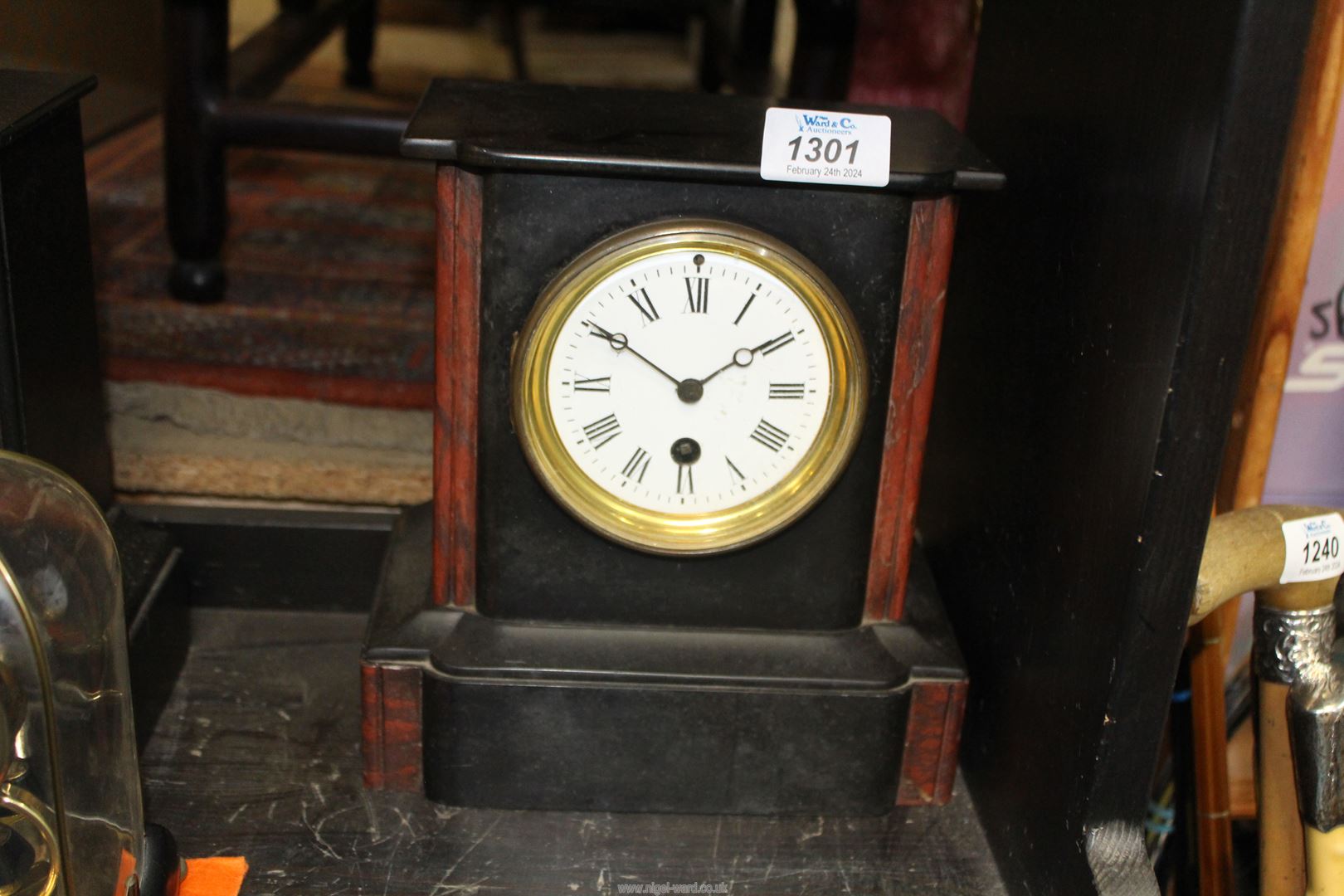 A slate and brown polished stone Mantle Clock having Roman numerals on a white face, back fixed,