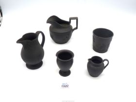 Five pieces of black basalt china, including miniature jug and vase, both marked Wedgwood,