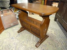 A Priory Oak/Old Charm style Oak occasional table having a magazine storage well beneath with linen