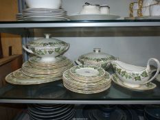 A Wedgwood Dinner service in an "Ivy" pattern, two lidded tureens, gravy boat and saucer, etc.