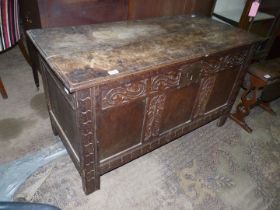 A peg-joyned three panel Oak Blanket Chest/Coffer having carved scroll and floral detail,