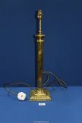 A brass effect Table Lamp with reeded column, 22'' tall.