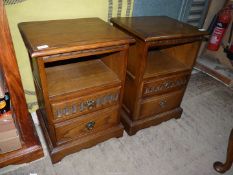 A pair of Priory Oak/Old Charm style Bedside Cabinets having two short drawers,