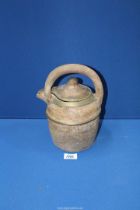 An earthenware water Vessel with handle and metal edging, 10 1/2" tall.