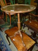 A compact snap top Mahogany occasional table standing on a turned pillar with splay feet,