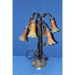 A six branch Lily type table Lamp with cast metal dragonfly base with orange/green shades,