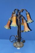 A six branch Lily type table Lamp with cast metal dragonfly base with orange/green shades,