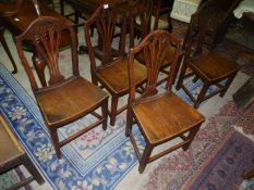An unusual set of five Georgian Oak Dining Chairs having dished solid Oak seats,