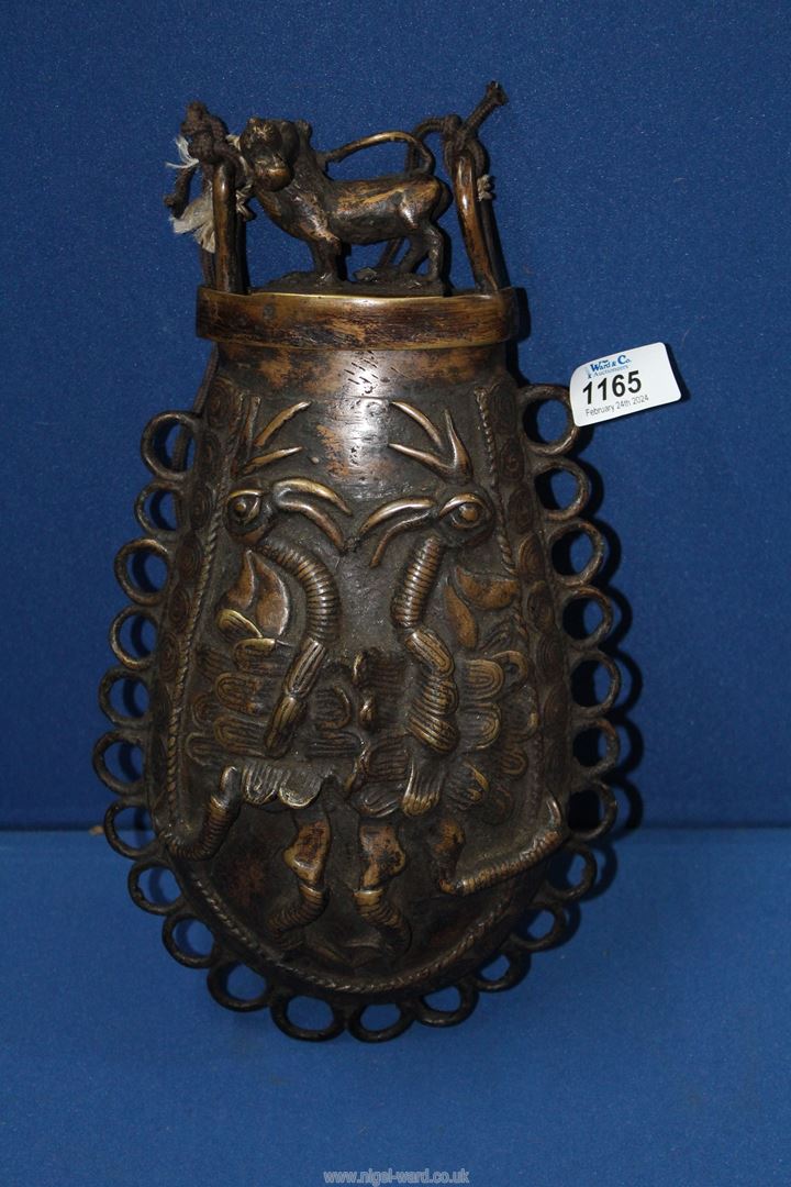 An early 20th century Benin bronze Talisman vessel, decorated with strange animals in bold relief,