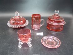 Two Cranberry glass lidded dishes, small mug, small dish on clear legs and saucer (chipped).