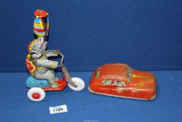 A clockwork Elephant on a Tricycle [West German] and a tin plate Fire Department car made in