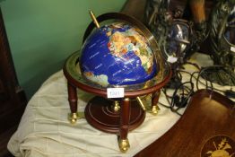 A semi precious stone Globe on a brass and wood stand, 15'' tall.
