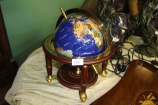A semi precious stone Globe on a brass and wood stand, 15'' tall.