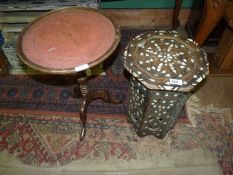 A small octagonal table inlaid with mother of pearl, some damage, 12 1/4" wide x 16 1/4" high.