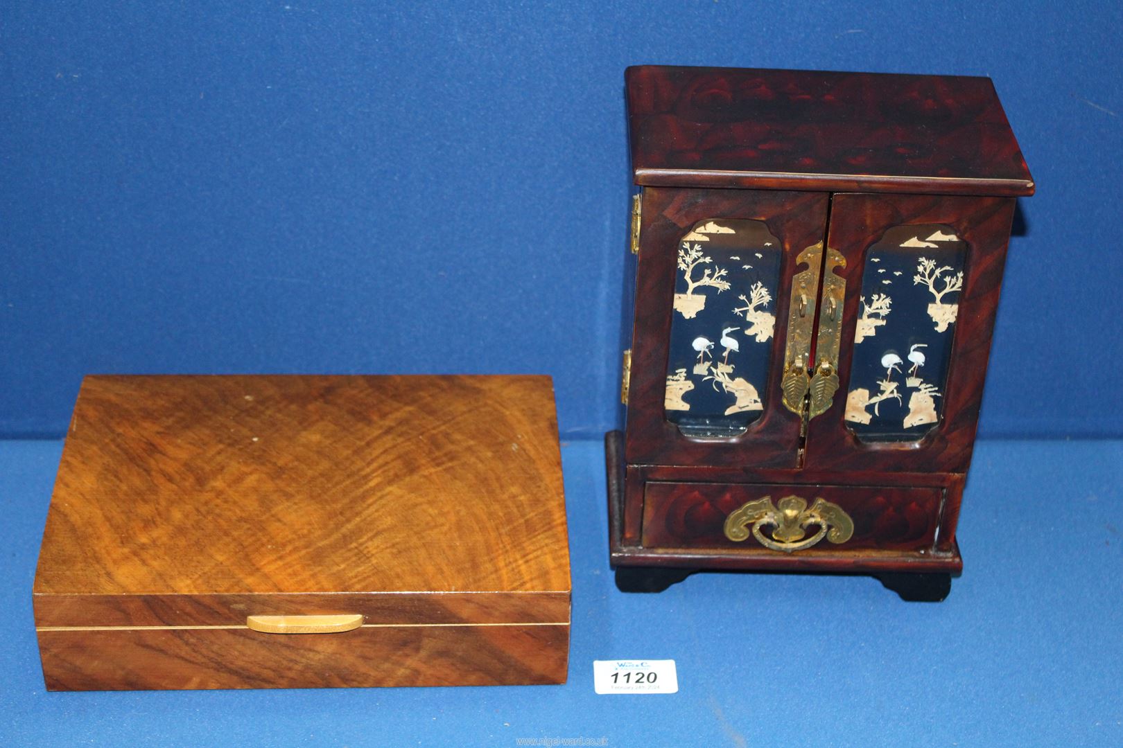A Chinese lacquered jewellery cabinet with drawers and cupboard, mounted brass fittings,
