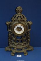 A German made metal clock in ornate lightweight frame, 15 1/2" high.