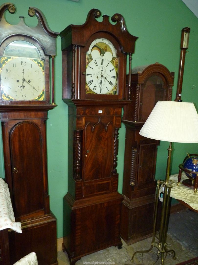 An imposing cross-banded Mahogany cased Longcase clock having arced painted face with Roman