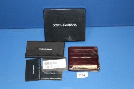 A boxed Dolce & Gabbana brown leather wallet, with certificate of authenticity.