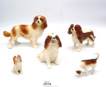 Five china dogs including; three Beswick, one Sylvac, plus one other.
