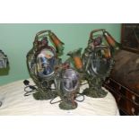 A pair of Figural Lamps of a Lady arching over a mirror with green and orange shade,