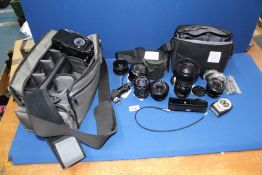 A quantity of Canon cameras; Zoom, 35-105mm, f3.5 lens, FD with case, 28mm, f2.