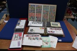 A red stock book with used and mint Great British and some foreign stamps,