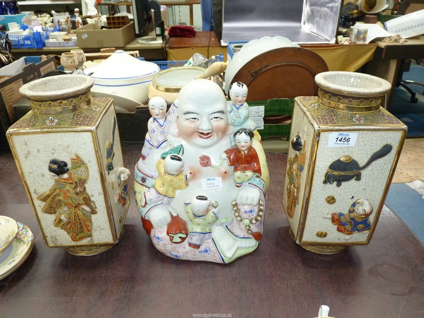A pair of Oriental square vases, and a laughing Buddha with Children.