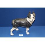 A heavy cast metal model of a black and white Dog, 10" high.