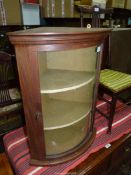 A Mahogany framed curved glass doored wall hanging display Cabinet with an olive green lined