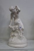 A contemporary model of a nude in classical pose on a rock, 18" tall.