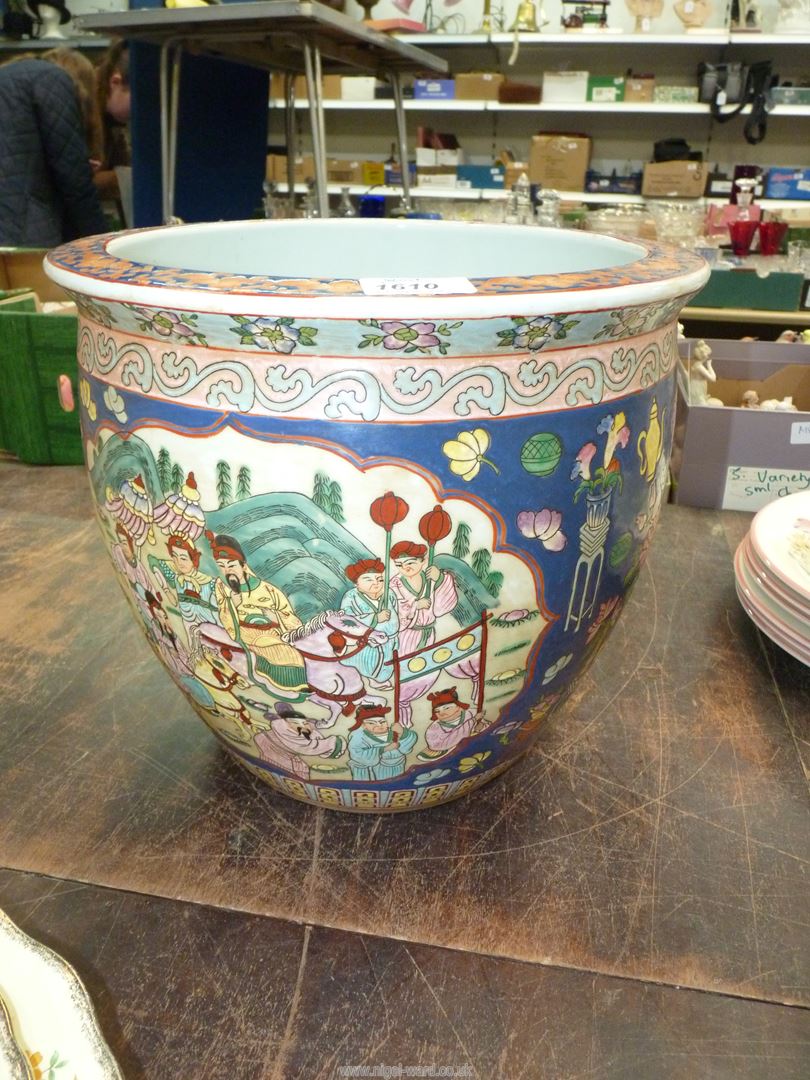 A Japanese porcelain fish bowl, the interior having orange fish and seaweed,