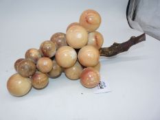 An unusual bunch of grapes ornament, the grapes appearing to be formed of alabaster,